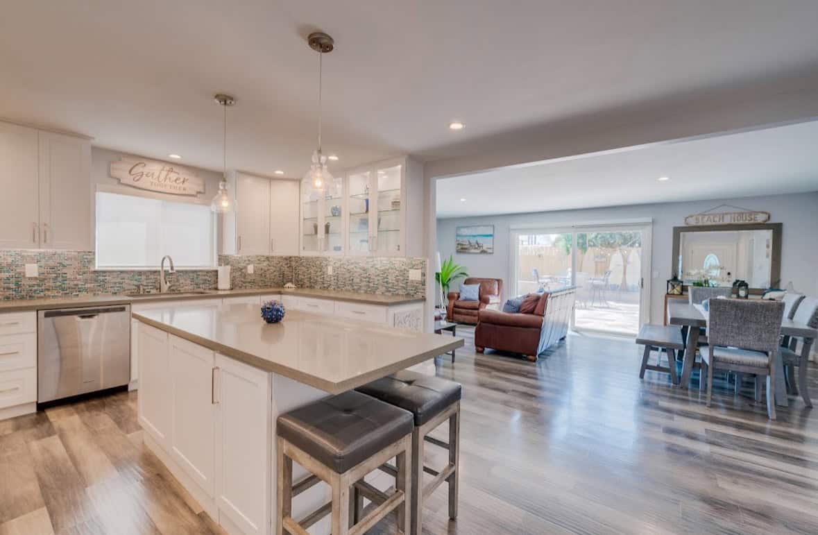 Open kitchen with island seating leading to the living area