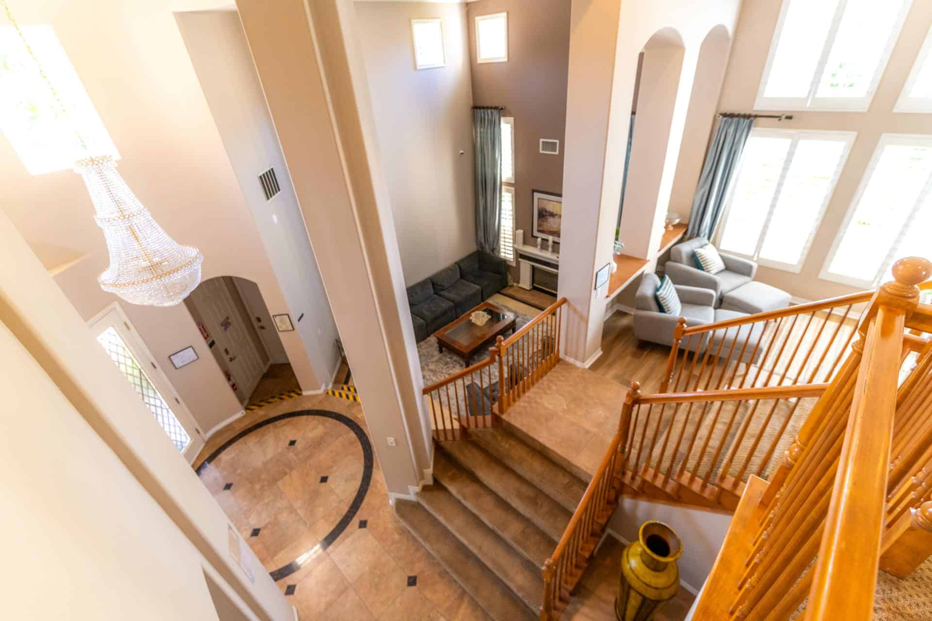 Two-story entryway with staircase and chandelier