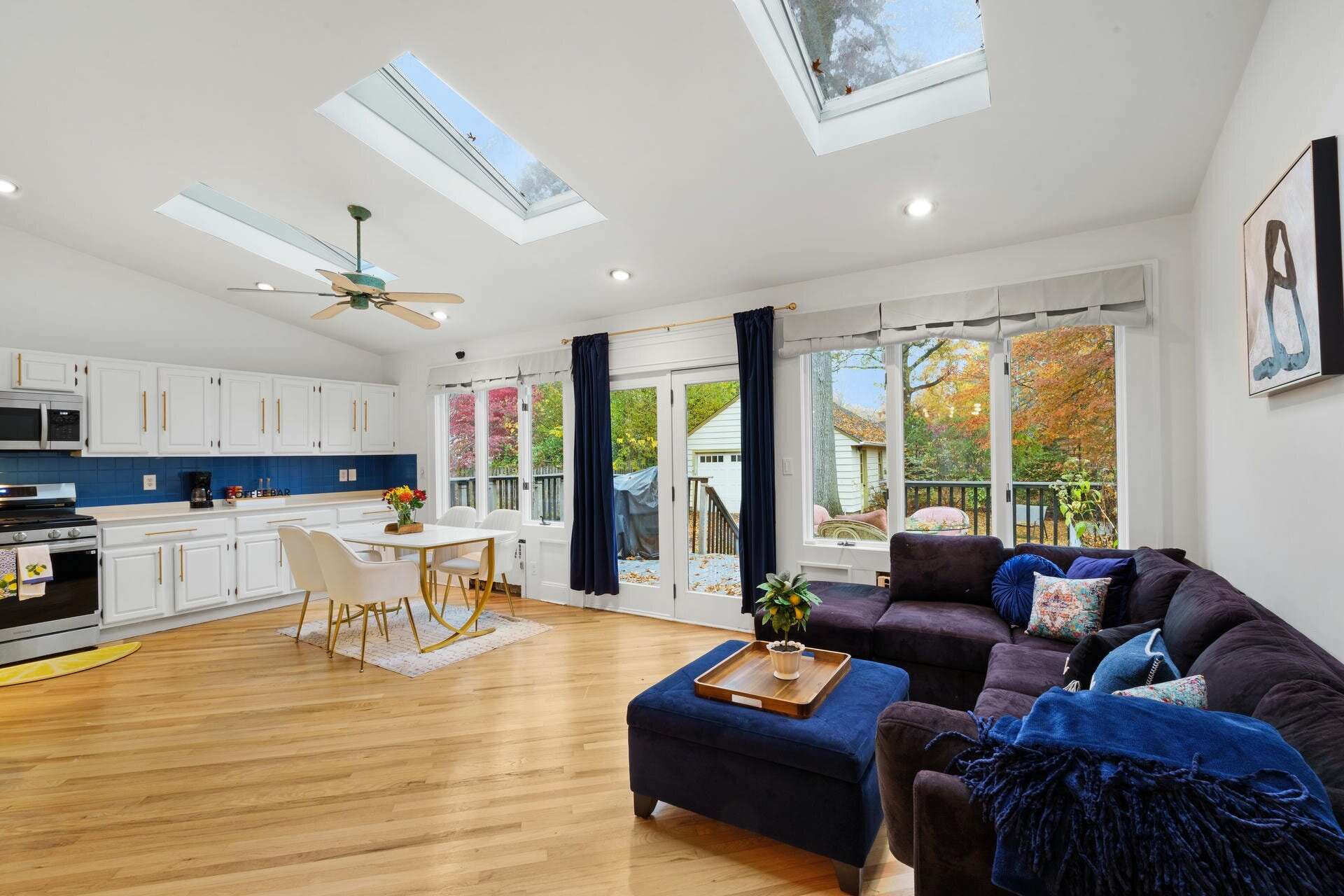 Bright open living and dining area with skylights