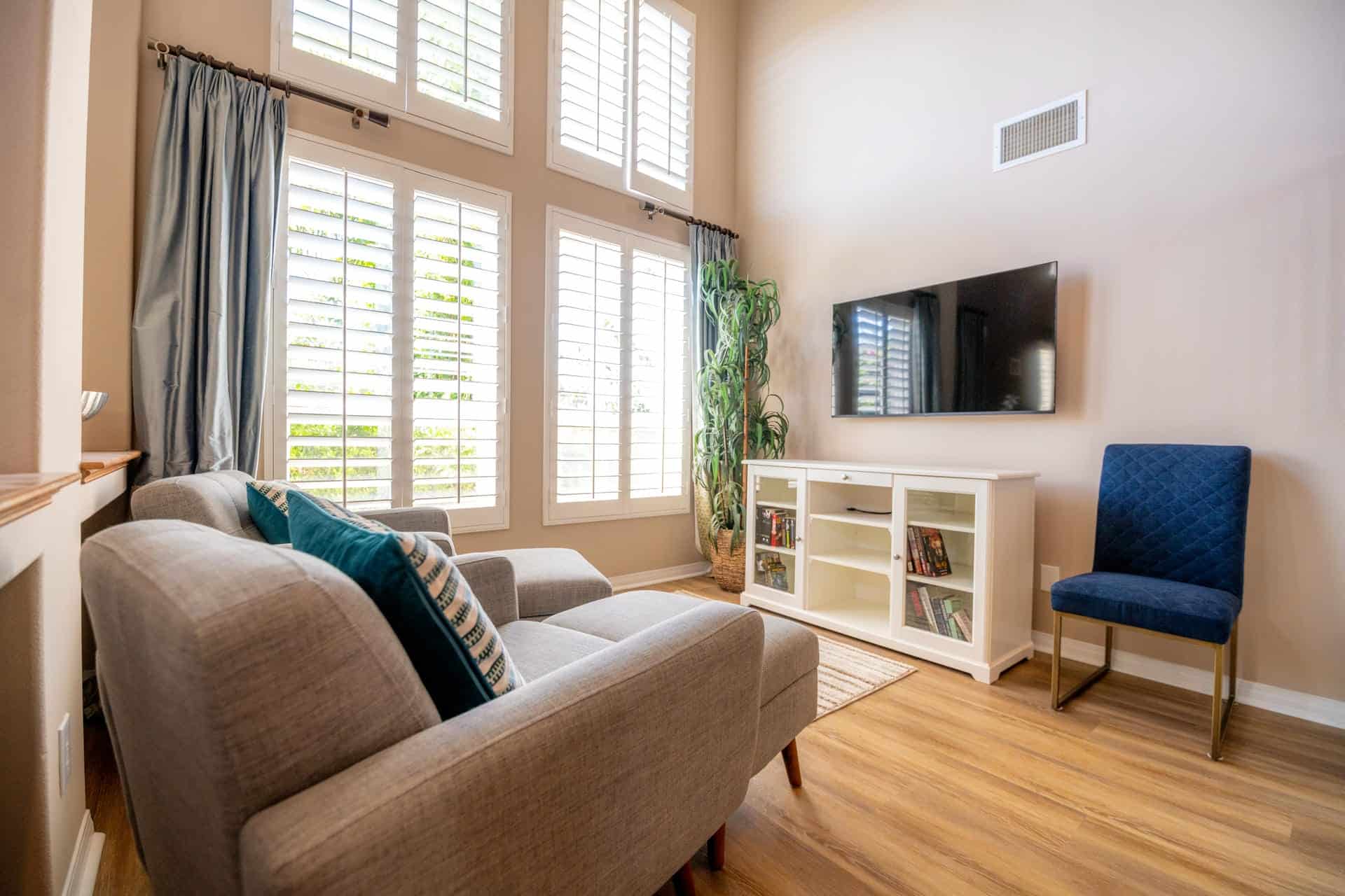 Comfortable living room with tall shuttered windows